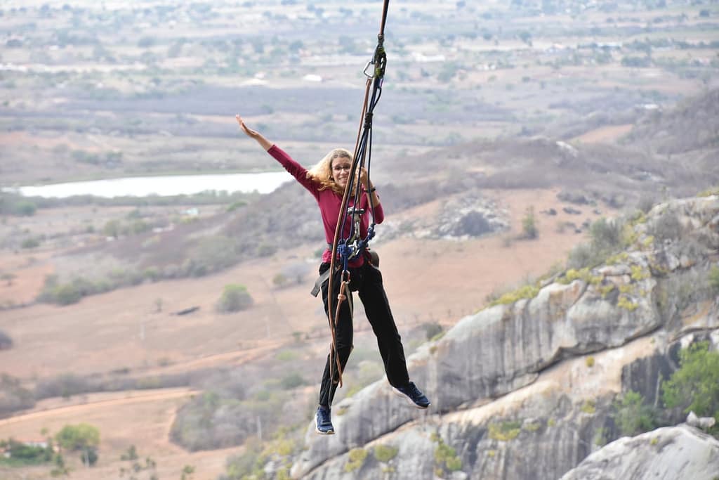 Emilly hanging from the pendulum at Pedra da Boca